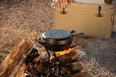 a pot is sitting on top of a campfire