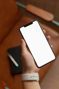 a person holding an iphone in their hand with a blank screen on the back side