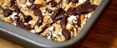 chocolate and marshmallows on top of oatmeal in a baking dish