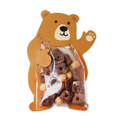 a bear shaped bag filled with nuts on top of a white table