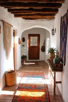 Spanish style hallway with rustic beams colorful tiles and rattan furniture blending traditional and bohemian elements Spanish Style Hallway, Spanish Hallway, Mexican Farmhouse, Style Hallway, Arched Doorways, Rustic Ideas, Entryway Inspiration, Ibiza Style, Foyer Decor