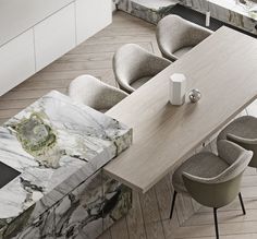 an aerial view of a dining room table with chairs and a marble bench in the center