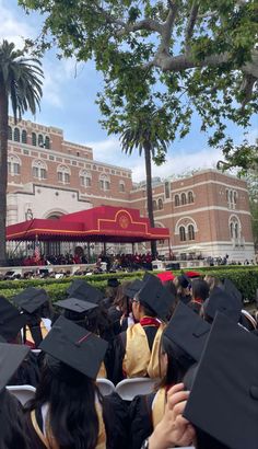 a group of people in graduation gowns and caps