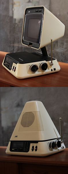 an old computer sitting on top of a wooden table