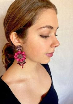 Colleen Toland Pretty Grand Fleur Earrings in Tea Rose.  The center flowers are hand beaded into a cluster of earring and are hand colored in a pretty copper color.  The petals are a deep red color.  The drops fall from a wired drape on the bottom and are red glass fire-polish and vintage red barrel beads. Length is 3.5 inches and width is 1.5 inches.  The posts are hypo-allergenic and the closure is a push back.  They can be converted to clip-on upon request. This is a quality piece of jewelry that will last a life time. Created by designer Colleen Toland who has been creating her unique style of vintage jewelry for more than 30 years. All of our pieces come with an engraved tag with Colleen's name so as you know you are receiving authentic Colleen Toland jewelry. We normally ship in 1 to Festive Red Flower Earrings, Red Beaded Flower Earrings, Elegant Red Beaded Flower Earrings, Red Beaded Flower Earrings For Party, Deep Red Color, Tea Rose, Tea Roses, Big Flowers, Copper Color