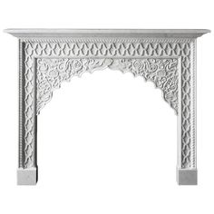 an ornate white fireplace mantel