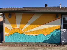 a house painted with the sun and clouds