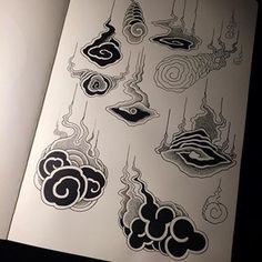 an open book with black and white designs on it's pages, including eyeballs