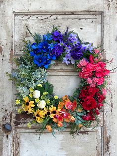 an old door with a colorful wreath on it