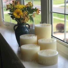 some candles are sitting on a window sill