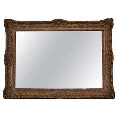 an ornate gold framed mirror against a white background