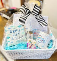 a white basket filled with baby items on top of a table