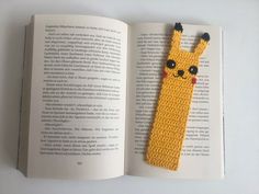 a bookmark made out of legos is sitting on top of an open book