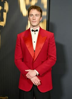 a man in a red suit and bow tie