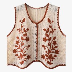 a white vest with red flowers and leaves on the front, made out of crochet