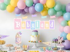 a babyland themed party with balloons and cake