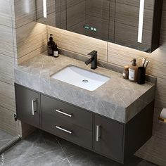 a bathroom sink sitting under a mirror in front of a counter top with soap dispensers