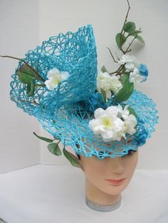 "* This design sits off to the side of the head allowing it to be worn on either the right or left side. One side features more of the white flowers and the other side has more of the folding. * The hat form is 14\" in diameter with a light weight weave and designed with white silk Wild Roses. Tiny turquoise daisy like flowers pick up the color in the hat forms. * It is light weight, balanced and comfortable to wear and upon ordering you will receive this exact fascinator. * Designed on a wide a Spring Turquoise Headpiece For Parties, Turquoise Fascinator For Spring Wedding, Turquoise Headpieces For Spring Weddings, Spring Wedding Turquoise Headpieces, Spring Turquoise Fitted Fascinator, Kentucky Derby Fundraiser, The Wizard Of Oz Costumes, Art Hats, Tiki Oasis