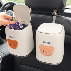 two white containers filled with candy and candies in the back seat of a car