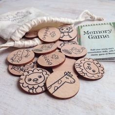 wooden buttons with animals on them sitting next to a bag