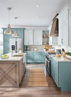 a large kitchen with blue cabinets and wooden floors is pictured in this image from the front view