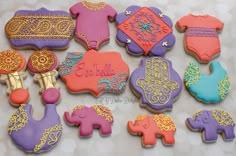 decorated cookies are arranged in the shape of elephants, giraffes and other items