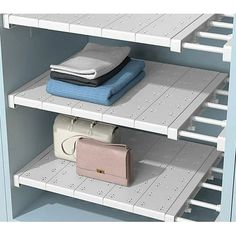 two shelving shelves with towels and purses on them