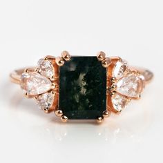 an image of a ring with stones on the front and side, including a green tourmaline