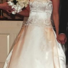 a woman in a wedding dress holding a bouquet