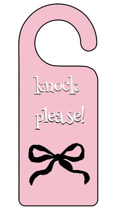 a pink door hanger that says knock please with a black bow on the front