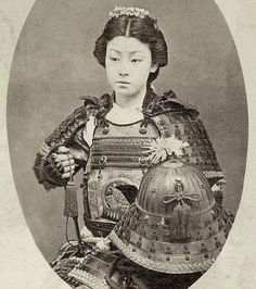 an old photo of a woman with a helmet on her head and holding a large object