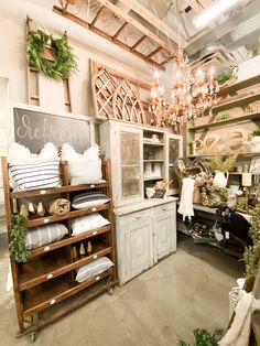 a room filled with lots of furniture and decor on display in front of a chalkboard