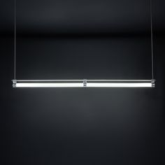 a suspended light fixture in a dark room