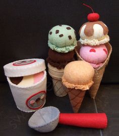 three ice cream cones, one with a cherry on top and the other with an ice cream cone