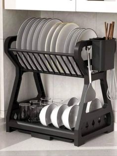 the dish rack is holding many plates and utensils in it's holder