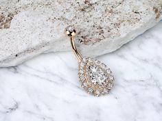 "Super cute and sparkly clear cz teardrop gem center and floral decor non dangle rose gold belly button piercing. Super cute and perfect for everyday wear.  - Material: Surgical steel - Thickness: 14g - Barbell length: 3/8\" (10mm) (Standard) - Hypoallergenic and nickel free. - Anti tarnish and allergy free. ------------------------------------------------- * Each item is crafted and handled with care to provide our customers with top quality products. * If you have any questions about any of ou Belly Button Piercing Rings, Button Piercing, Belly Button Piercing