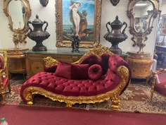 an ornately decorated living room with red and gold furniture