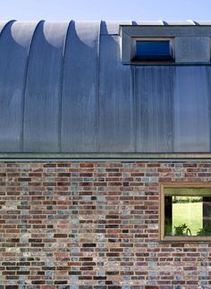 a brick building with a metal roof and windows