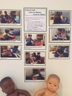 two dolls sitting next to each other in front of a wall with pictures on it