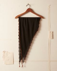 This triangle scarf is inspired by a beaded scarf from the 1920s-1930s. The original trim—made from hand-threaded bugle beads—has been replicated here and hand-applied along the edges.    100% silk Made in China Dry clean only   All wear, mending, and idiosyncrasies are unique to the custom textile. Trim Scarf, Beaded Scarf, Triangle Scarf, Bugle Beads, Beaded Trim, Scarf Shawl, Textiles, Trim, China