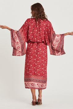 Behold a windswept bohemian beauty in Coa Kimono! Vibrant and floral sheer fabric flows to the beat of an artsy vibe. Thanks to its wing-like long sleeves and midi length, this kimono robe ensures full coverage for swim suit babes. Gracefully show your appreciation with Coa Kimonos as special bridal party gifts. Infuse down time with flower power. Details: bohemian style Coa Kimono long sleeves midi length matching waist sash colorful floral print fabric is sheer Fabric + Care: Rayon, Cotton blend. Machine wash with mild detergent. Tumble dry normal or line dry for best shape. Steam or iron to your liking. Coa Kimono, bohemian style fall outfit, cute fall outfit ideas, floral kimonos, pretty kimono robe, bridal party gifts, ShoptheKei.com Long Sleeve Rayon Kimono For Spring, Free-spirited Boho Dress With Floral Print, Long Sleeve Boho Dress As Beach Cover-up For Spring, Long Sleeve Boho Dress For Spring Beach Cover-up, Long Flowy Boho Dress With Print, Fall Rayon Kimono With Kimono Sleeves, Flowy Boho Print Kimono For Fall, Flowy Boho Print Dress With Kimono Sleeves, Spring Boho Print Maxi Dress