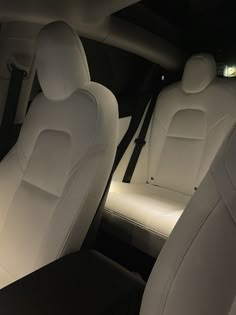 the interior of a car with white leather seats