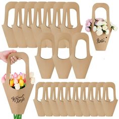 a bunch of brown paper bags with flowers in them and one person holding a flower pot