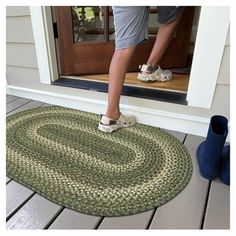 a person stepping into a door with their feet on the mat in front of them