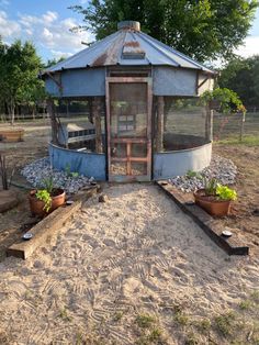 a small gazebo sitting on top of a dirt field