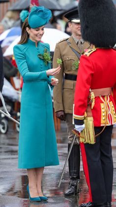 the royal couple are standing outside in the rain