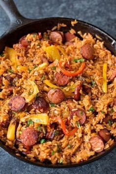 a skillet filled with rice and sausage