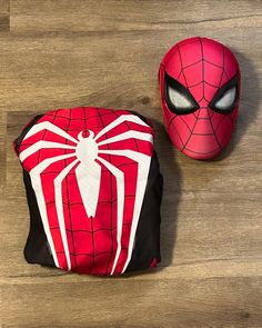 two spiderman bags sitting on top of a wooden floor