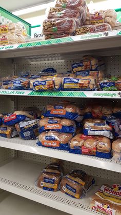 bread and other foods are on shelves in a grocery store