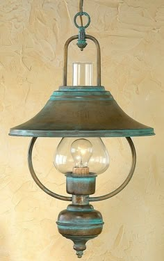 an old fashioned light fixture hanging from the ceiling with two lamps on each side and one lamp in the middle